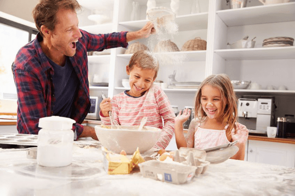 Man baking with boy and girl in the kitchen